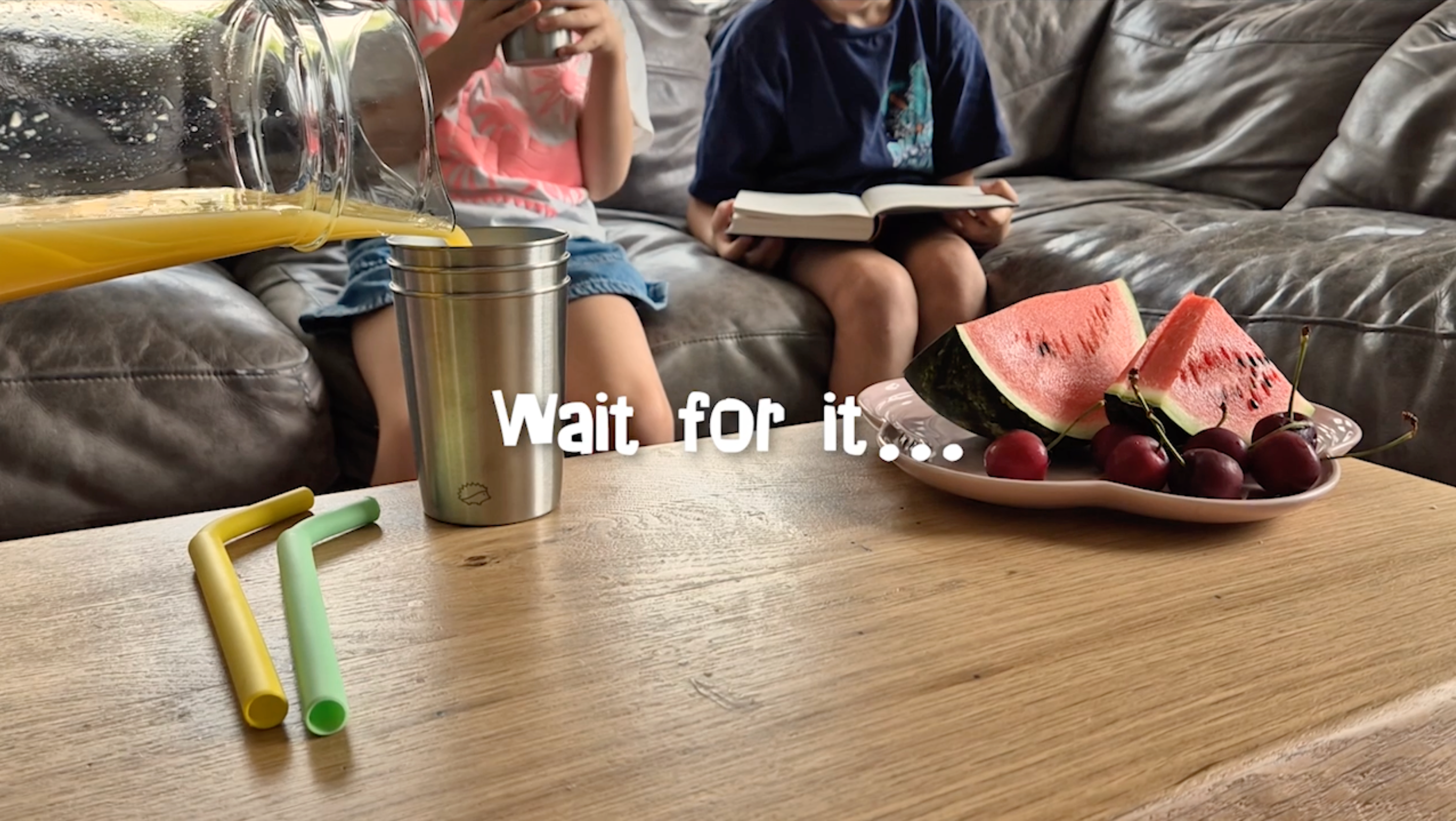 Load video: Children drinking from steel cups, in blissful moment of calm